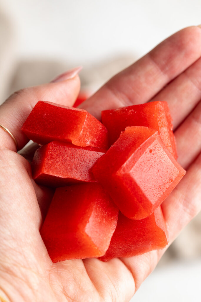 hand holding strawberry lemonade electrolyte gummies.