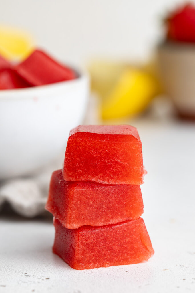 three strawberry lemonade electrolyte gummies stacked on a table.