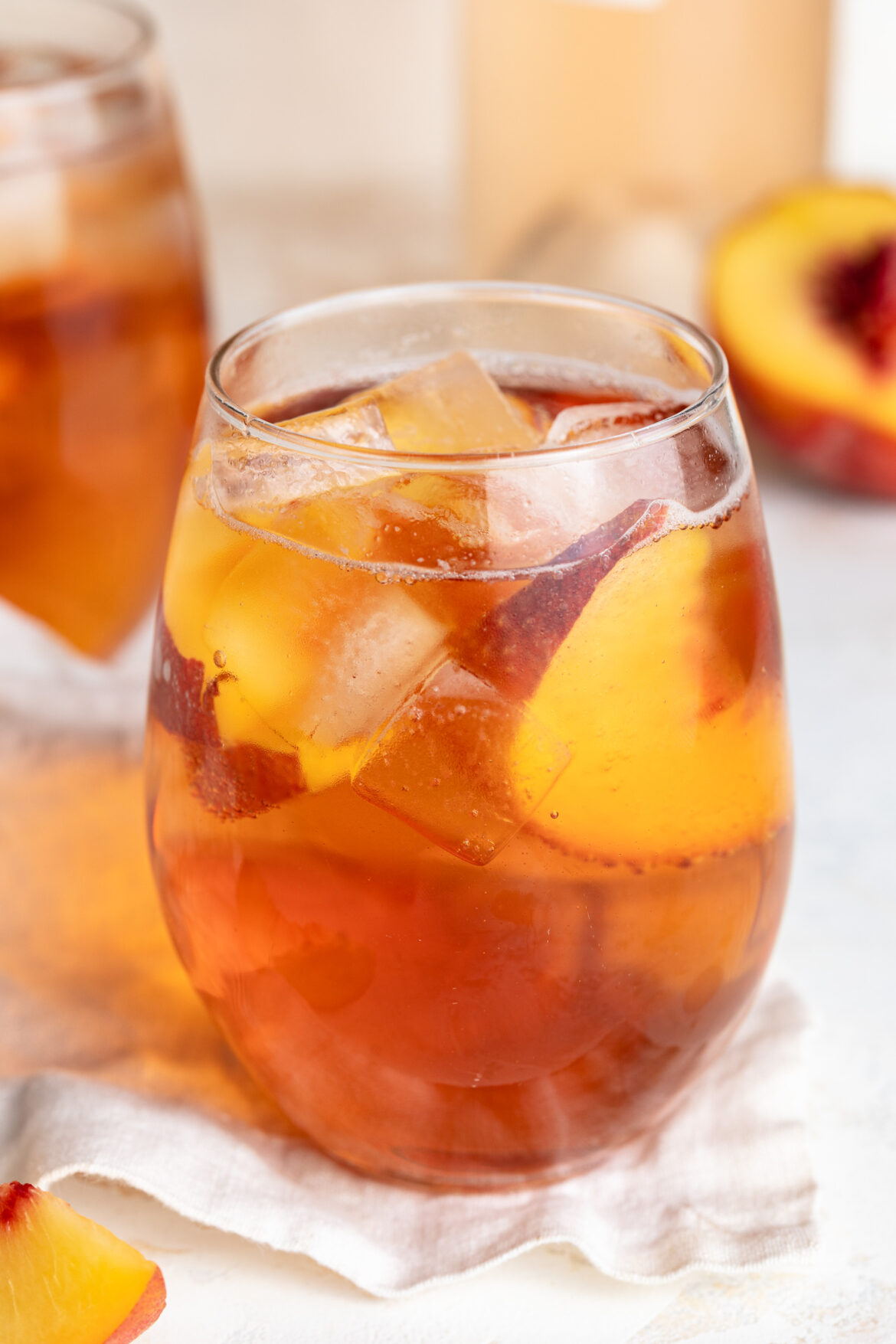 a glass of summer rose sangria with fresh sliced peaches inside.