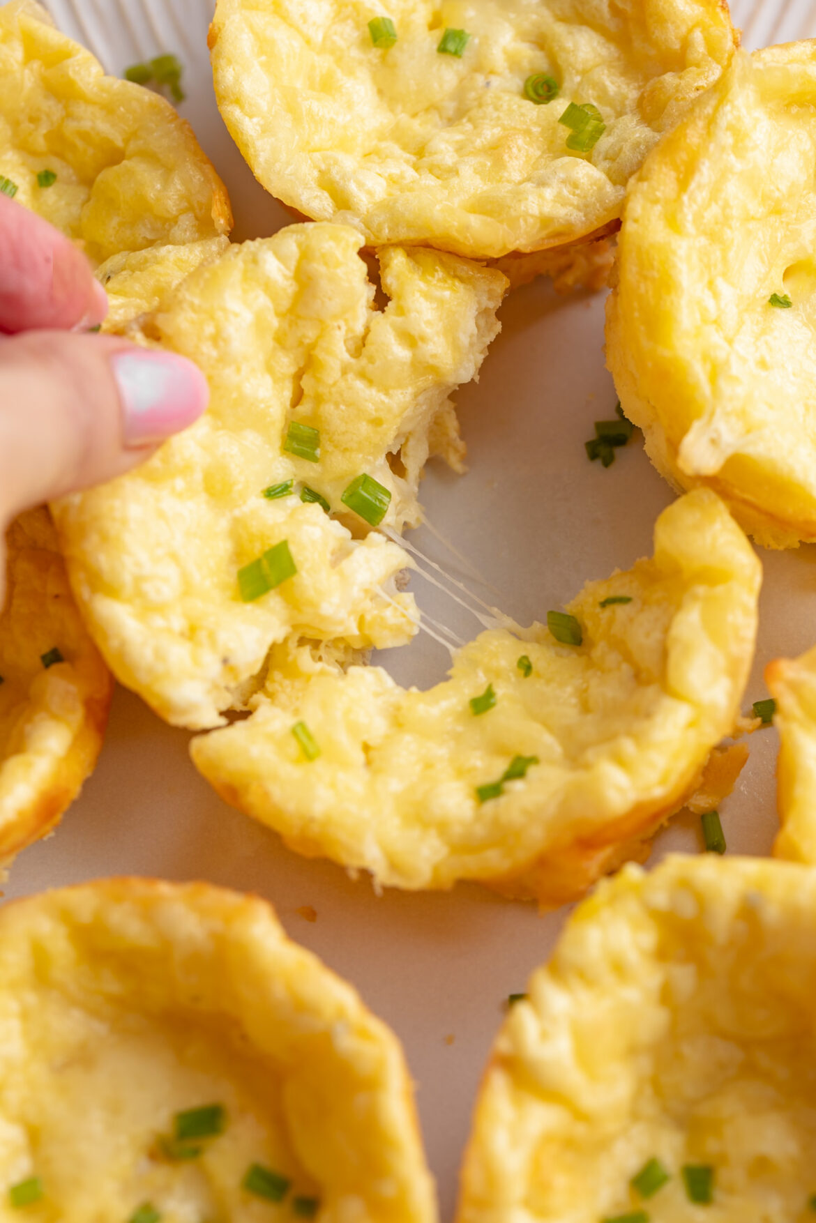 Ham & Cheese Cottage Cheese Egg Bites (just 4 ingredients!) Pulling apart a cheesy cottage cheese egg bite.