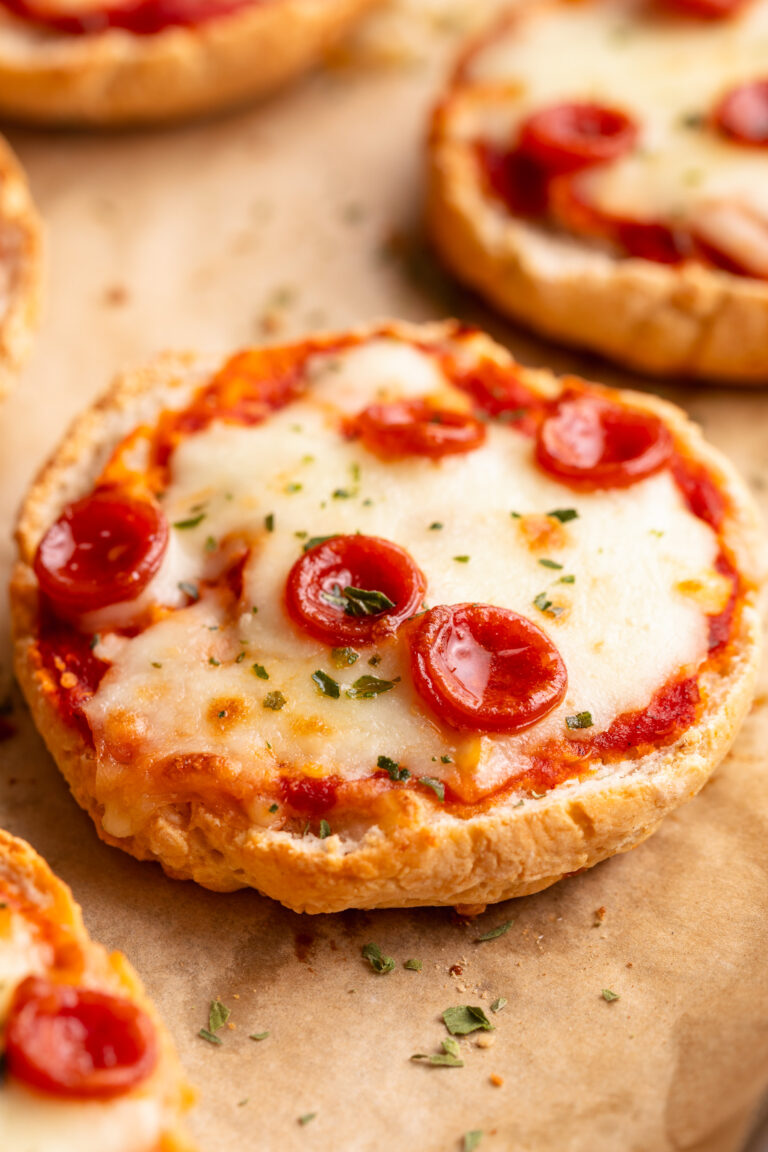 close up image of cottage cheese pizza bagels on a baking sheet.