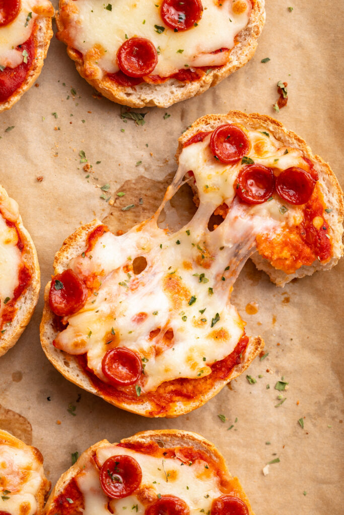 overhead image of cottage cheese pizza bagel being pulled apart.