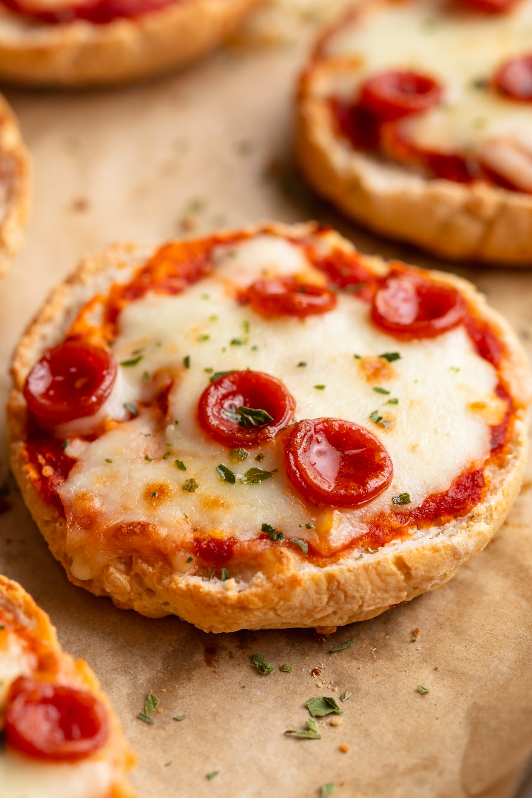 close up image of cottage cheese pizza bagels on a baking sheet.