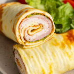cottage cheese wrap halves stacked on a plate.