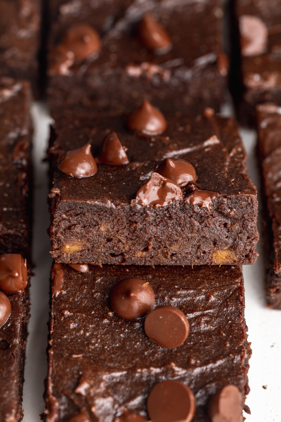 close up image of sweet potato brownies stacked on top of each other.