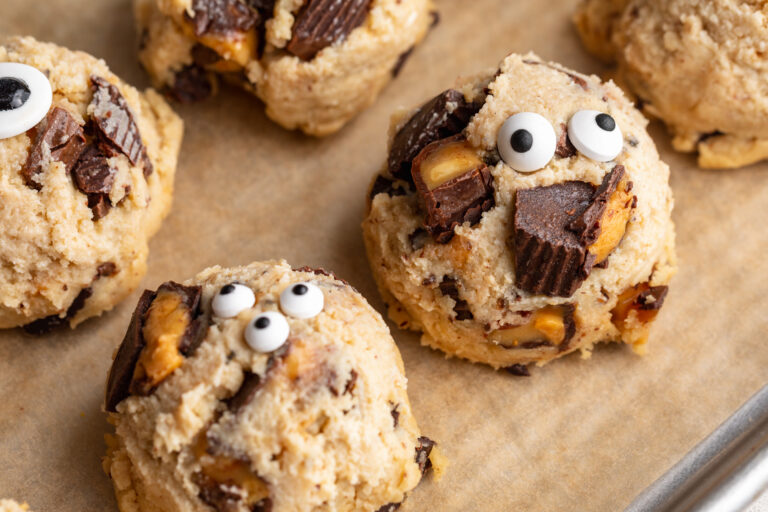 a row of cottage cheese monster cookie dough bite on a baking sheet.