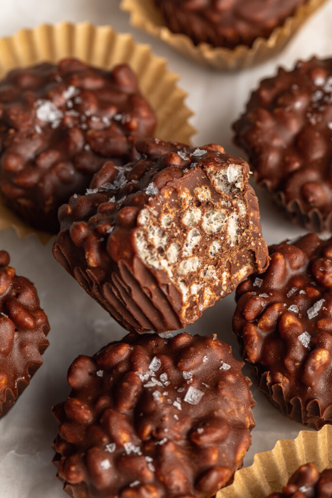 close up image of a crunchy peanut butter cup with a bite taken out.