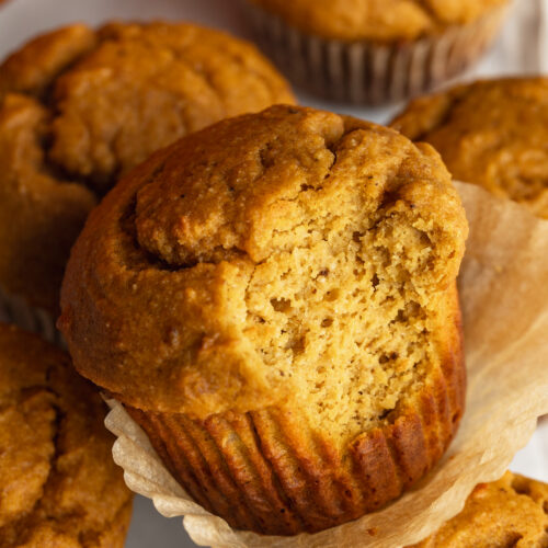 close up image of a pumpkin protein muffin with a bite taken out.